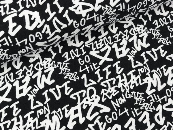 Baumwolljersey Confetti Buchstaben weiß auf Schwarz