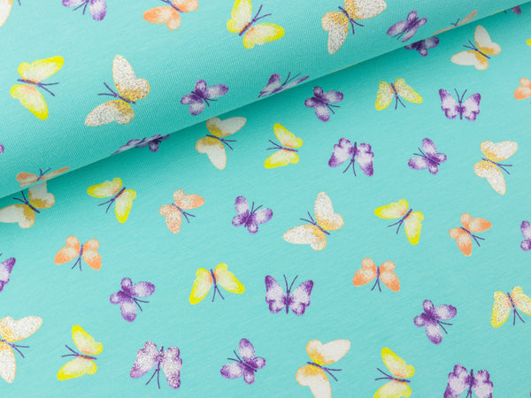 Baumwolljersey Glitter Butterflies bunt auf Aqua
