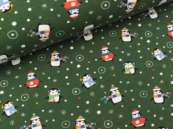 Baumwolljersey Pinguine im Schnee auf Dunkelgrün