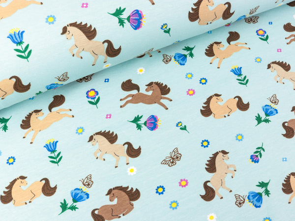 Baumwolljersey Glückliche Pferde auf Wasserblau