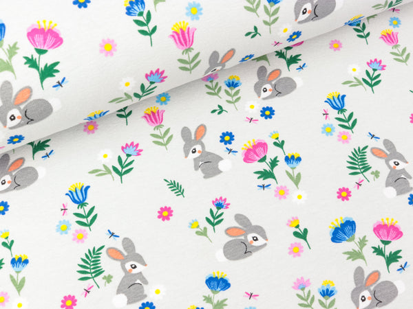 Baumwolljersey Kleine Häschen in der bunten Blumenwiese auf Lichtgrau